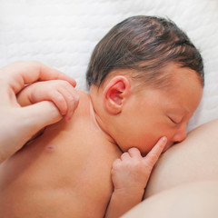 Newborn baby breastfeeding in the hospital.