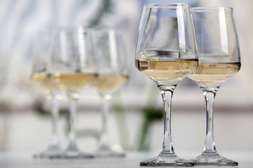 Glasses of white wine on table closeup