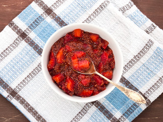 Chia puding with strawberry juice and strawberries in a bowl