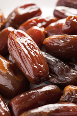 Dried dates in a white plate closeup