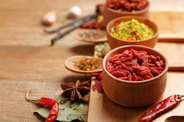 Assorted spices on wooden table closeup
