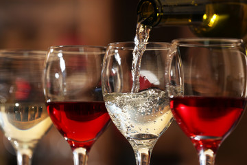 White wine pouring into wine glass, closeup