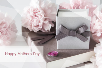 Gift box and carnation flowers on white background for mothers d