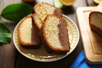 Fototapeta na wymiar Delicious sweet cake bread with lemons on wooden table closeup