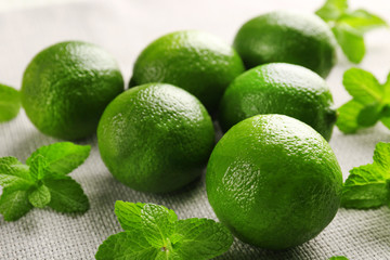 Limes and mint on wooden table