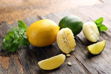Lemon and lime slices with mint on wooden table