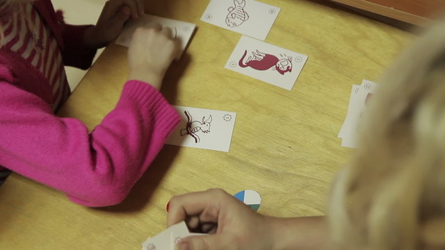 psychologist occupation in kindergarten with two girls, are testing the game
