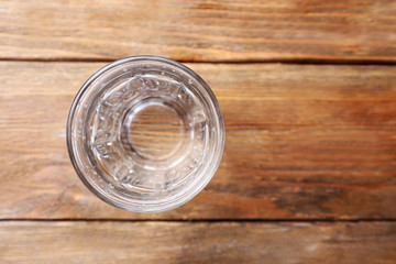 Glass of water on wooden background, close up