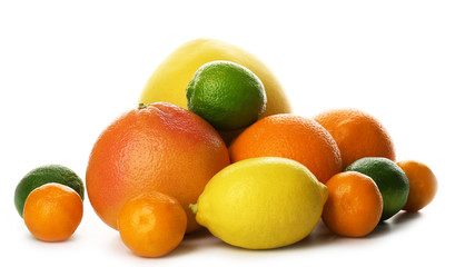 A heap of mixed citrus fruit including a grapefruit, oranges, lemons, clementines, tangerines, limes and a pomelo fruit isolated on a white background, close up