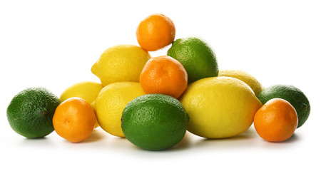 A heap of mixed citrus fruit including   lemons, tangerines, limes isolated on a white background, close up