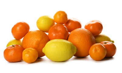 A heap of mixed citrus fruit including   lemons, tangerines, oranges isolated on a white background, close up