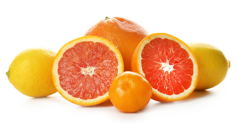 Mixed citrus fruit including sliced grapefruit isolated on a white background, close up