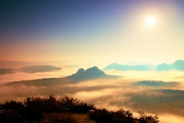 Fantastic dreamy daybreak above peaks of smoky mountain with the view into misty valley