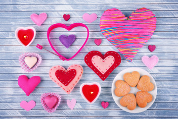 Valentine's Day concept. Beautiful composition of handmade hearts and tasty cookies on wooden background
