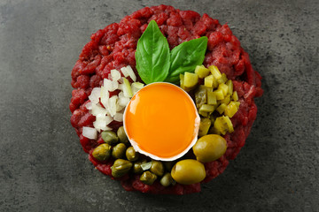 Beef tartare served on a grey surface, top view