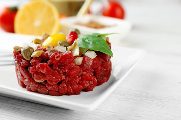 Beef tartare served on a plate, close up