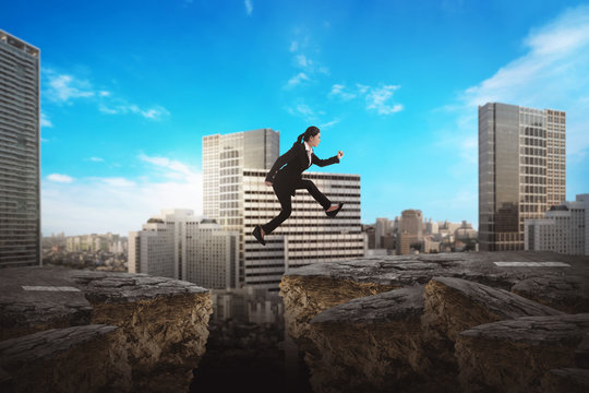 Asian Business Woman Jumping Over Broken Road