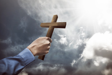 Human hand holding christian cross