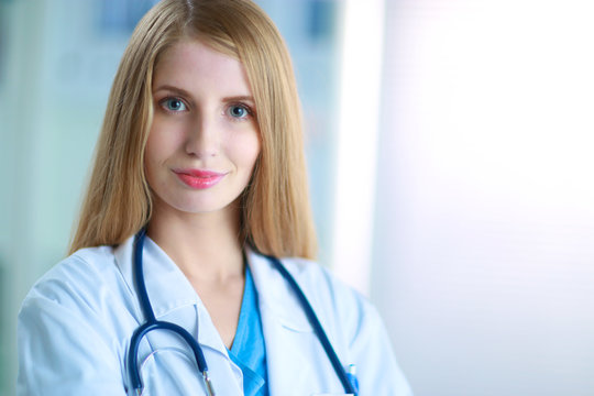 Doctor  woman is standing in the near window 