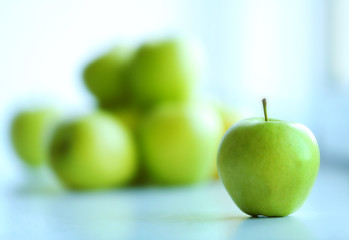 Ripe green apples on a windowsill