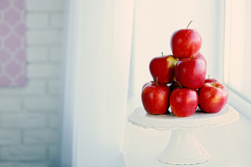 Ripe red apples on windowsill