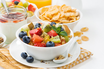 breakfast with fruit salad and corn flakes, closeup