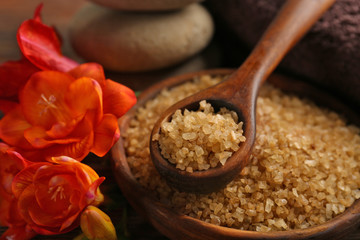 Spa set with sea salt, exotic flowers, pebbles and towel, close up