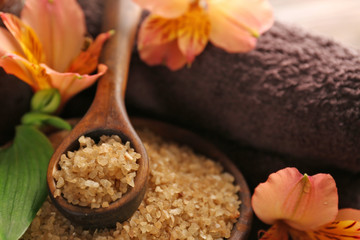 Spa set with sea salt, exotic flowers, candles and towel, close up