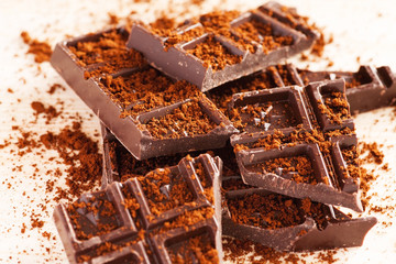 Pieces of dark chocolate on a wooden table