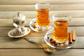 Glass cups of tea on wooden  background