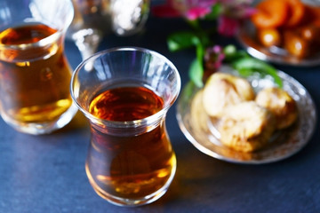 Glasses of tea on blue table closeup