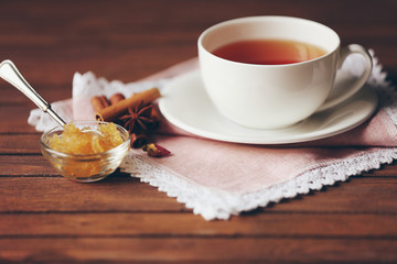 Cup of tea, honey and spices on table closeup