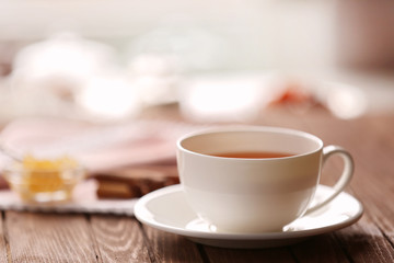 Cup of tea on light blurred background