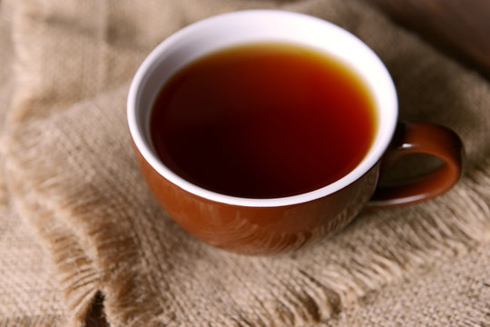 Cup of tea on sackcloth closeup