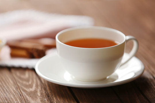 Cup of tea on wooden table closeup