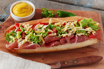 sandwich baguette ham jamon cheese with tomato and herbs