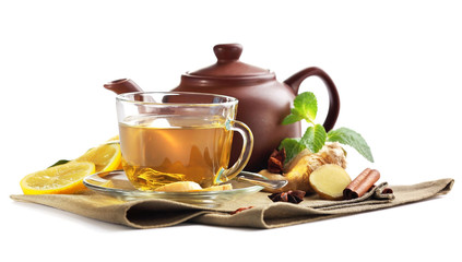 Cup of tea with ginger and cinnamon on napkin isolated on white