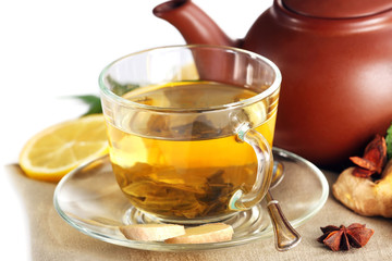 Cup of tea with ginger and cinnamon on napkin, closeup