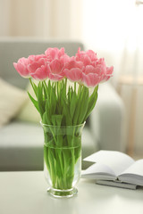 Spring bouquet of pink tulips on a white table.