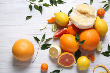 Various citrus fruits on wooden table