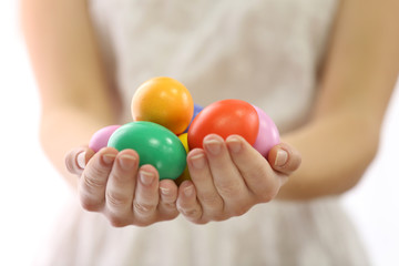 Female hands holding Easter eggs isolated on white