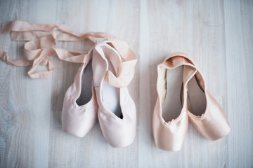 Two pairs of pointe shoe on the wooden floor, lifestyle, hobbies, dancing, choice
