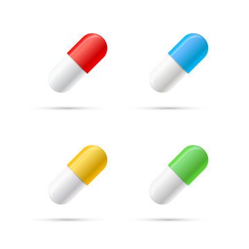 Set of different colours pills, capsules on white