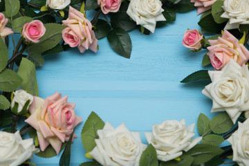 Bouquet of roses on blue wooden background