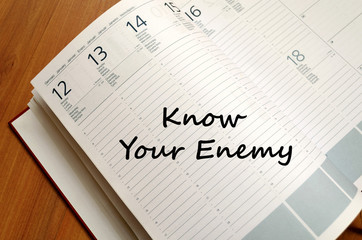 Know your enemy write on notebook