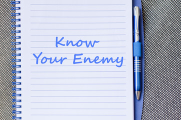 Know your enemy write on notebook - 105838941