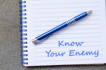 Know your enemy write on notebook - 105838947