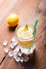 glass of lemonade with ice on table
