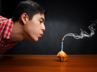 Birthday boy blowing out the candle