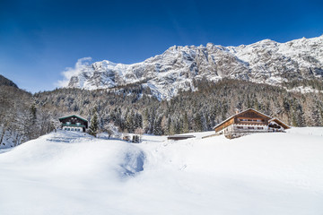 Winter wonderland in the Alps with traditional farm houses